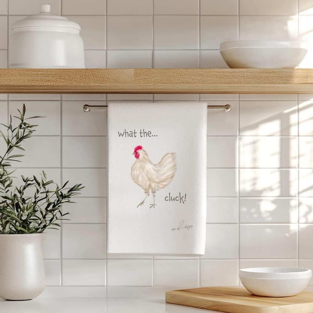 brown chicken with the saying...what the,cluck on a flour sack tea towel