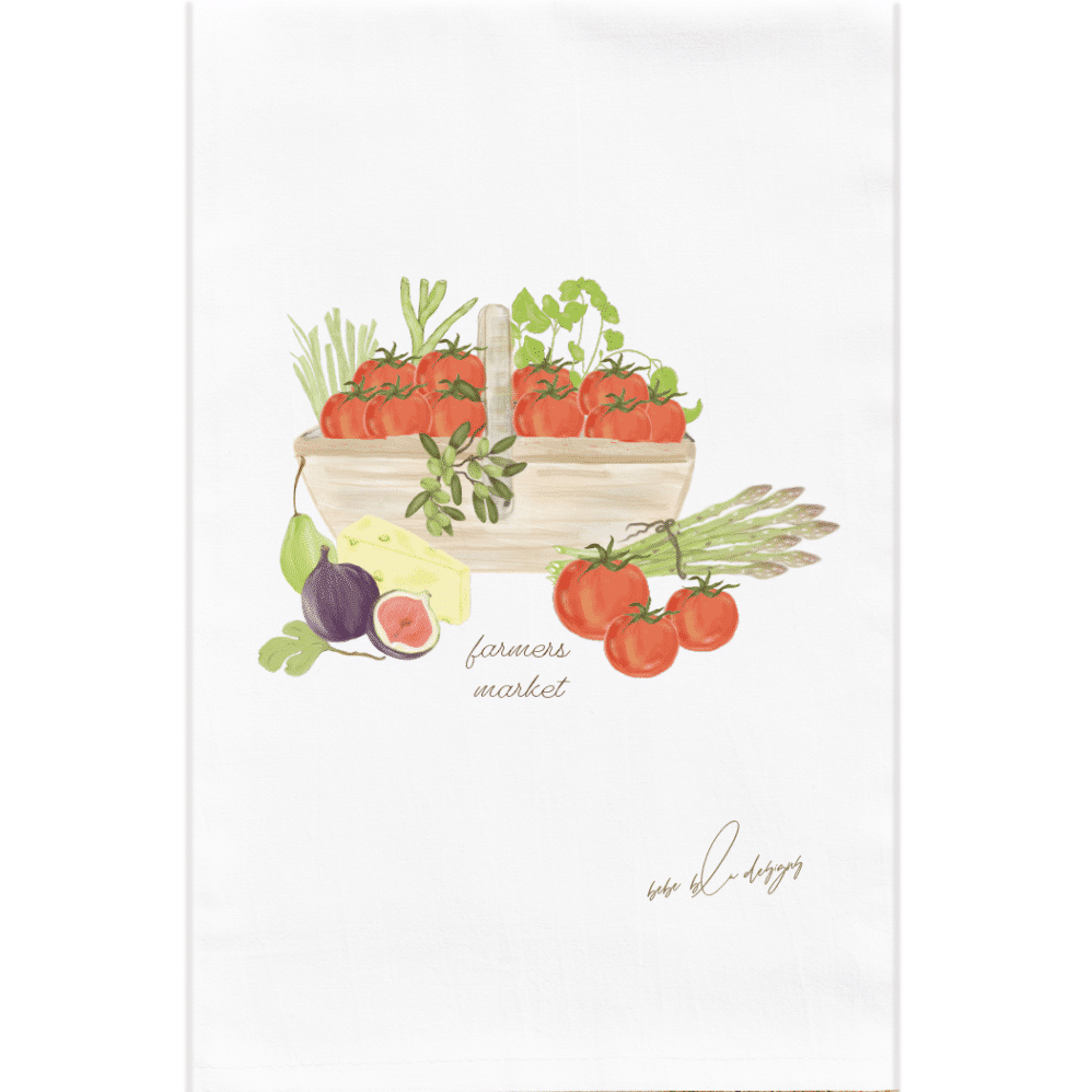 A colorful farmers market wooden basket flour sack towel filled with tomatoes, figs, cheese and more.