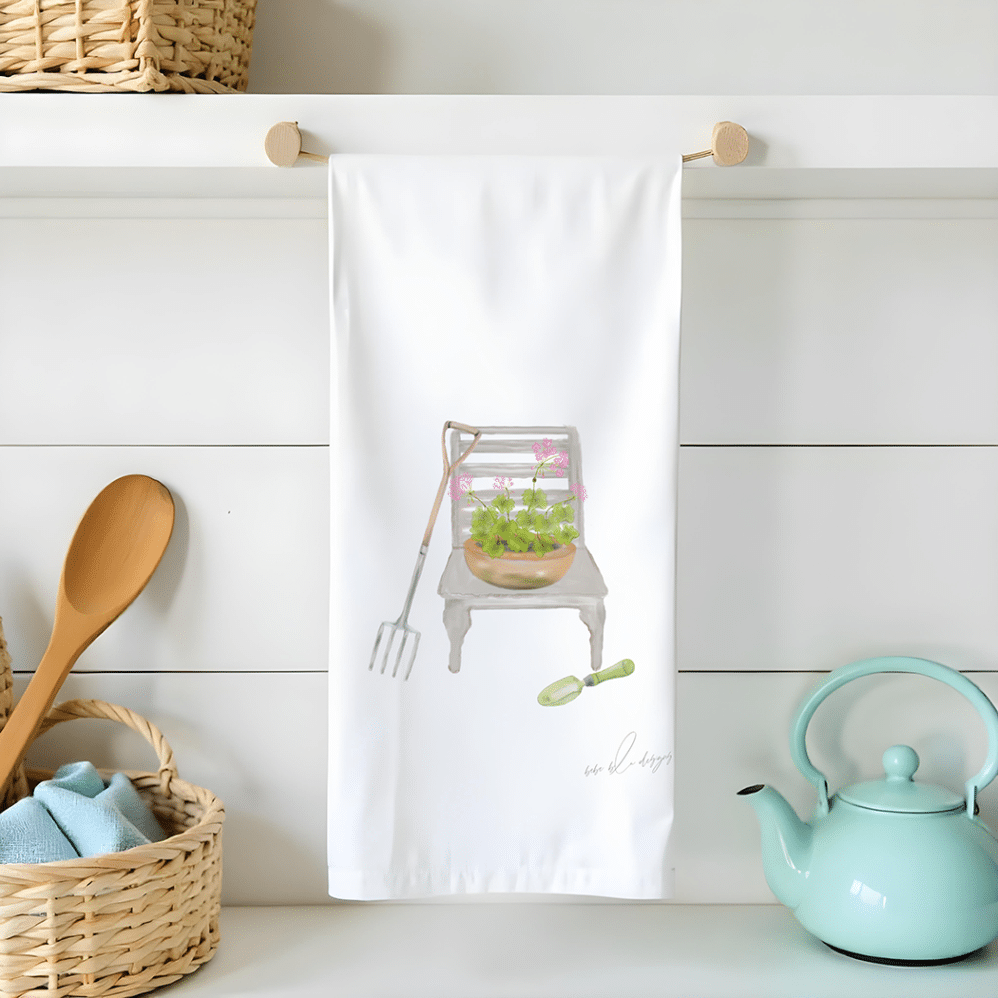 garden chair with a pot of geraniums on the seat on a flour sack towel