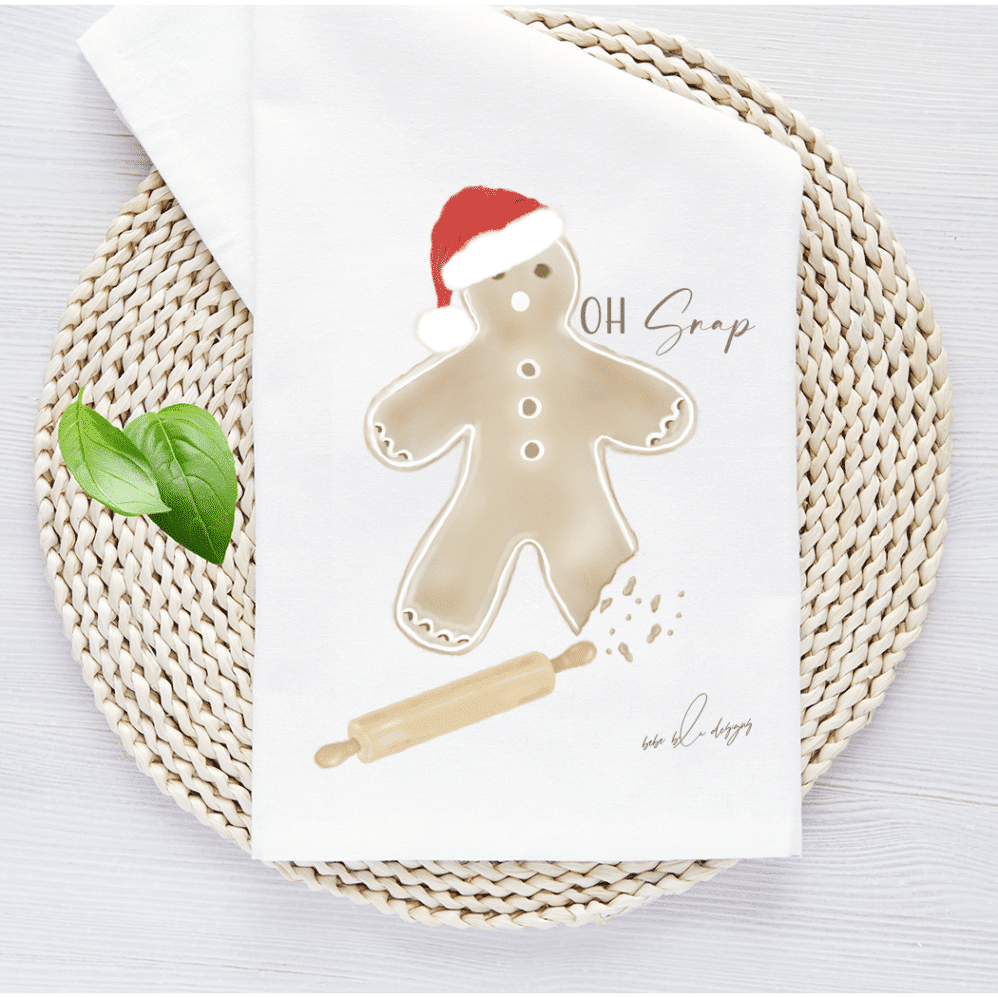 gingerbread man with a bite out of his leg and the words...oh snap. Included is a wooden rolling pin help to make this an adorable kitchen towel