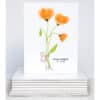 stems of orange poppies tied with twine on note card
