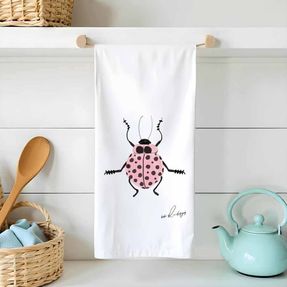 pink ladybug on a flour sack tea towel