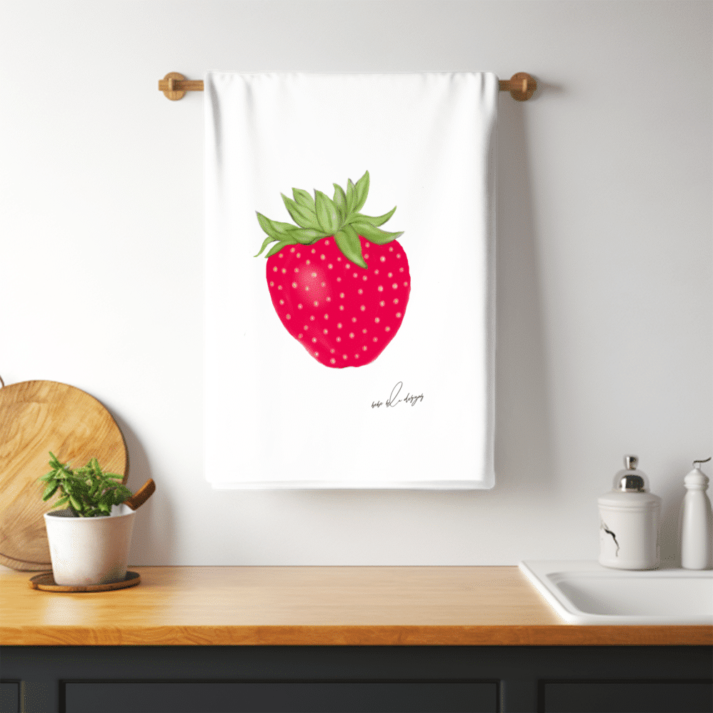 a red strawberry on a flour sack tea towel