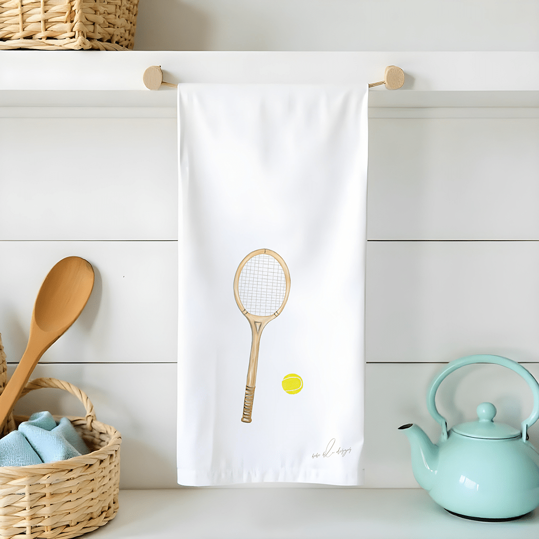 tennis racquet and ball on a flour sack tea towel